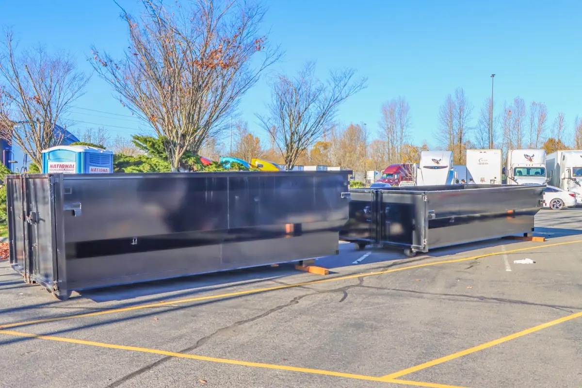 Professional dumpster rental service with roll-off container on residential driveway in Sidney